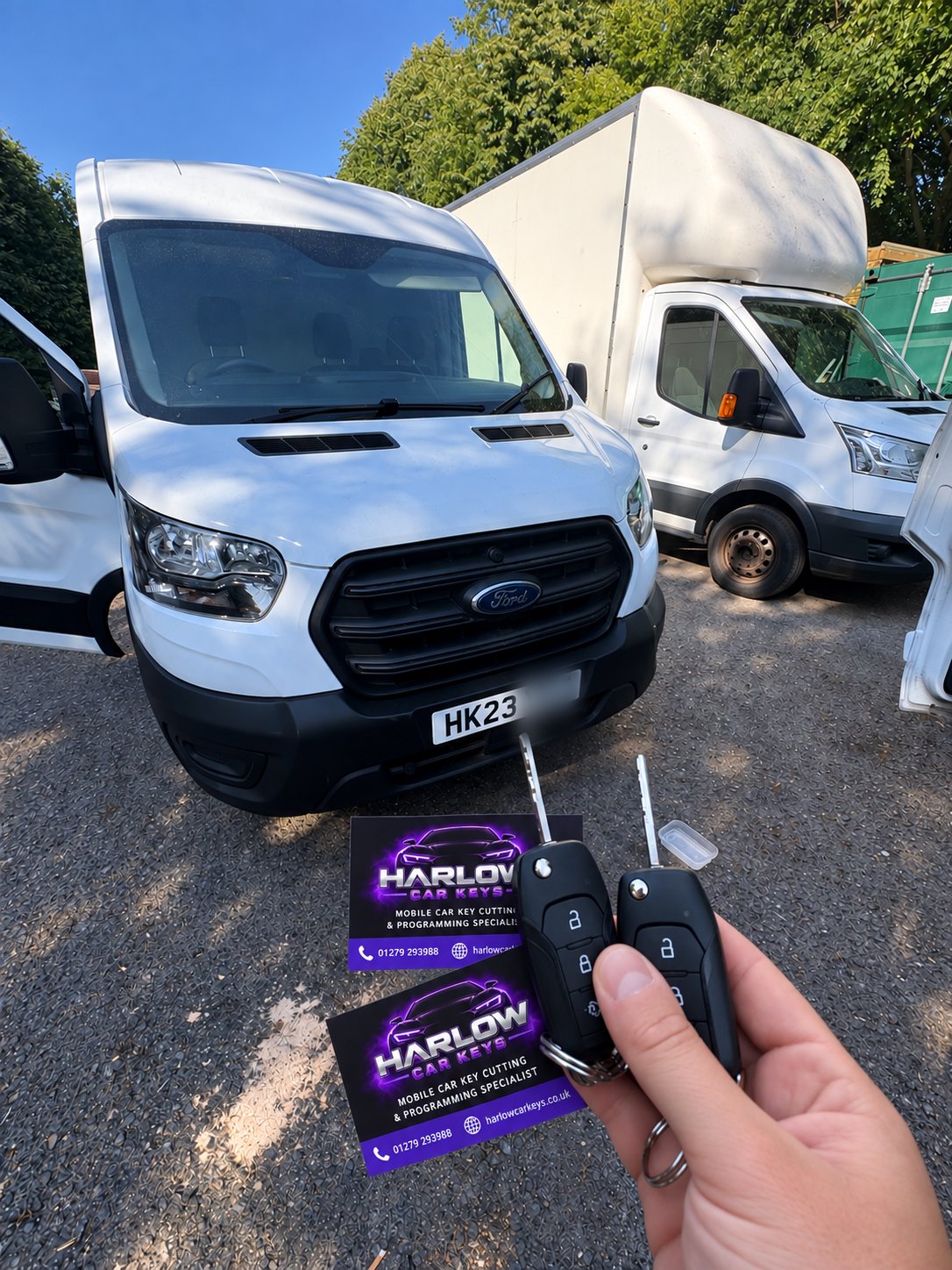 Two keys for a 2023 Ford Transit, held in front of the van with Harlow Car Keys business cards