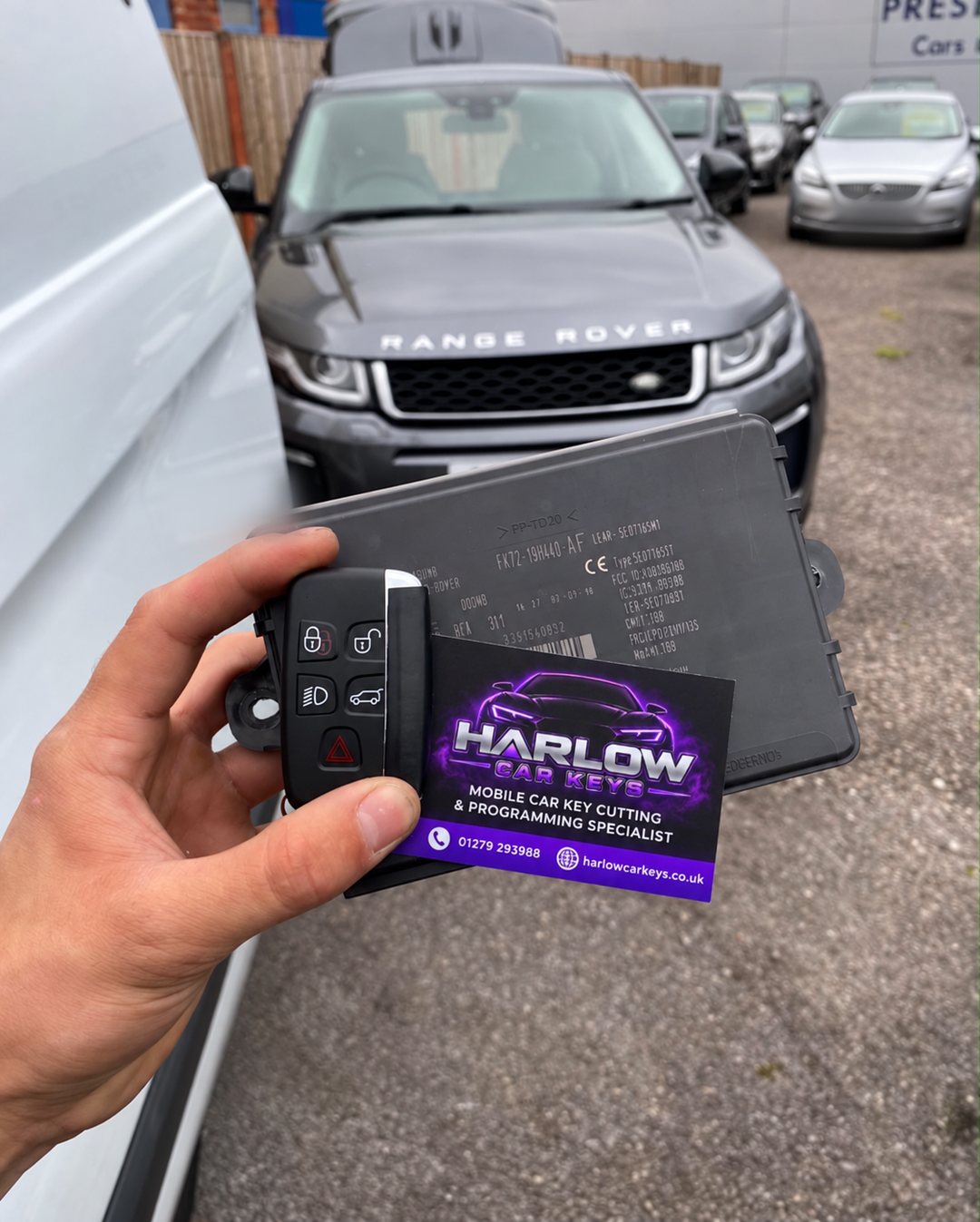 Newly programmed key for a 2015 Range Rover Evoque in Old Harlow, Harlow after all keys were lost, held in front of the vehicle with a Harlow Car Keys business card