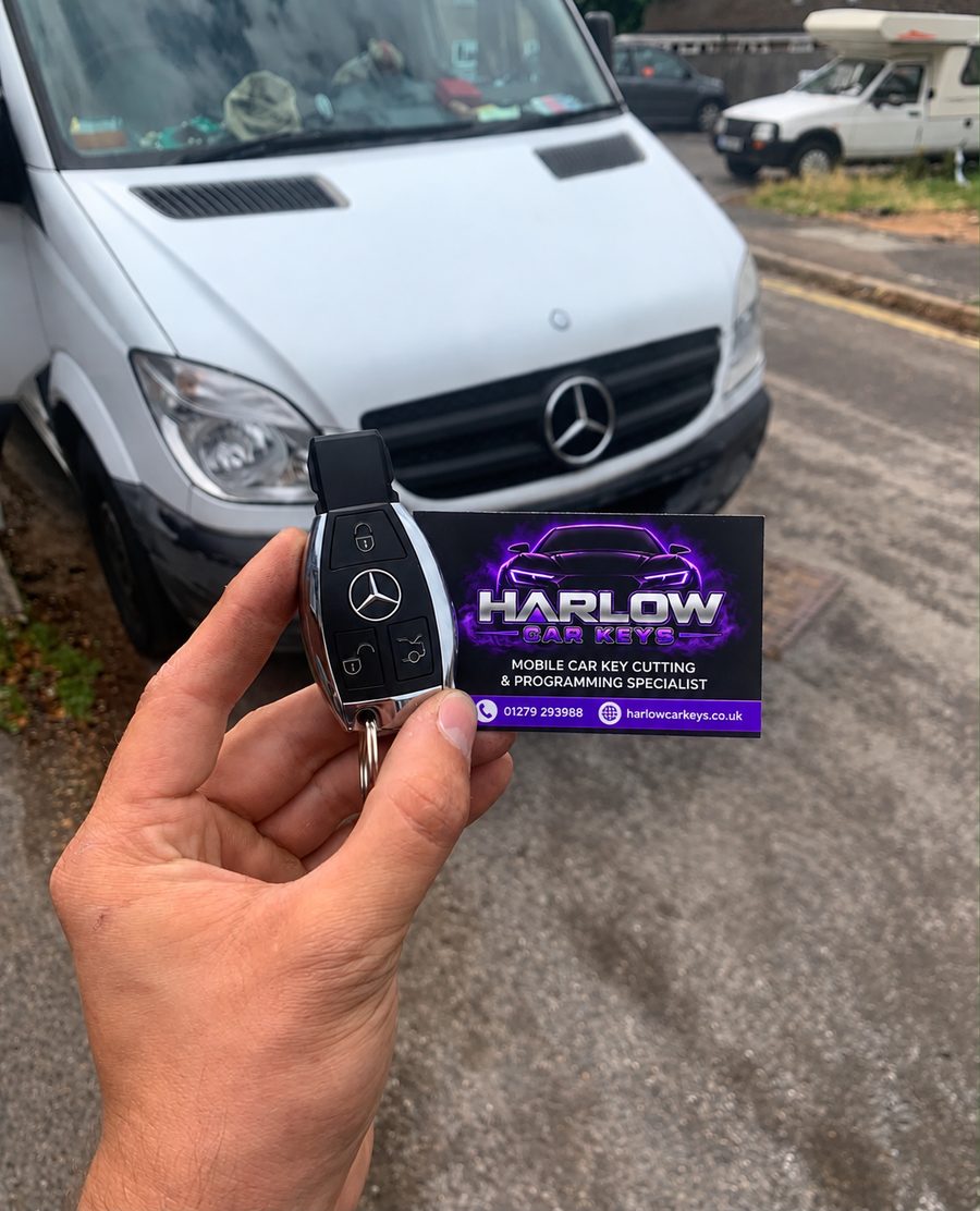 Newly made key for a 2016 Mercedes Sprinter in Church Langley, Harlow after all keys were lost, held in front of the van with a Harlow Car Keys business card