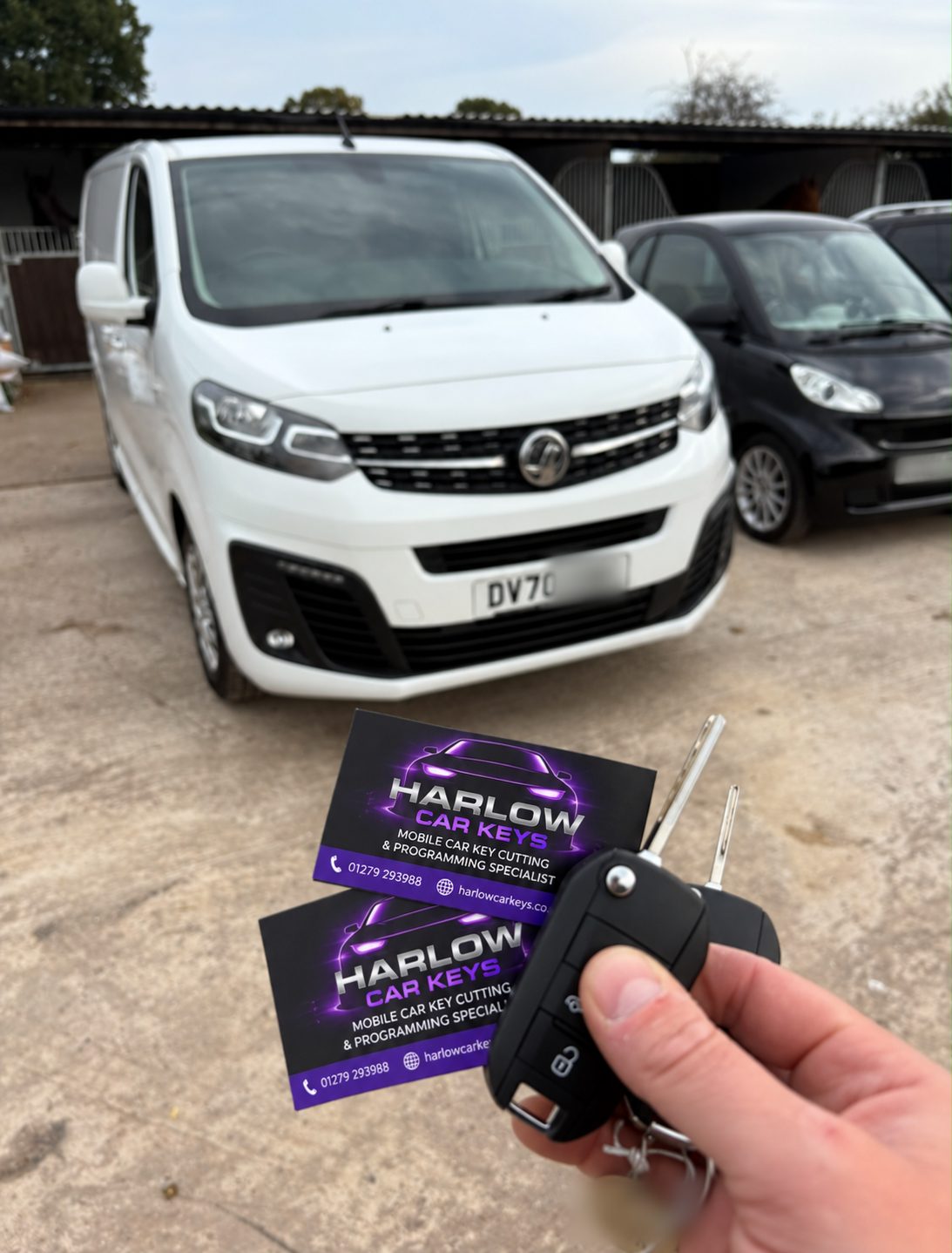 New remote key supplied for a 2020 Vauxhall Vivaro in Hertford after the old remote stopped working, held in front of the van with Harlow Car Keys business cards